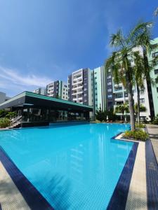 a large swimming pool in front of buildings at Manhattan Condominium Ipoh in Ipoh