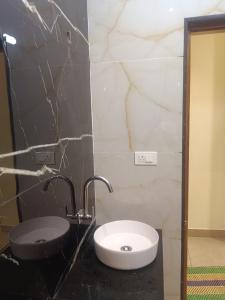a bathroom with a sink and a toilet at VGN Convention Centre in Vāniyambādi