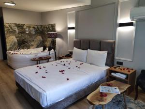 a hotel room with a bed with roses on it at Olen Uskudar Hotel in Istanbul