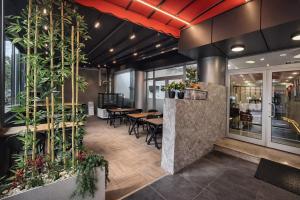 a restaurant with tables and chairs and plants at Olen Uskudar Hotel in Istanbul