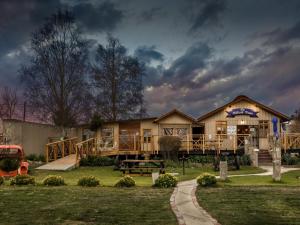 a large house with a porch and a playground at John Jack Inn Accommodation in Chrissiesmeer