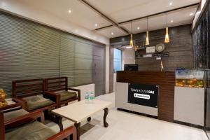 a restaurant with a table and a fish tank at Townhouse Oak Gravity Inn in Pune