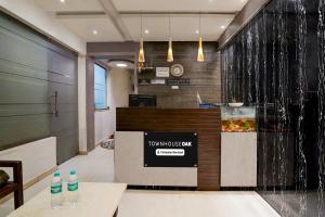 a restaurant with a counter with a fish tank at Townhouse Oak Gravity Inn in Pune