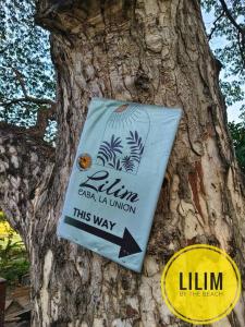 a sign on the side of a tree at Duplex A- Seaside Haven Transient Inn at Caba, La Union in Caba +3 photos
