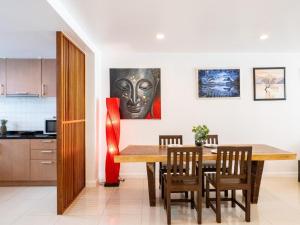 a kitchen and dining room with a table and chairs at Townhouse Six9 The Pool Residence in Koh Samui