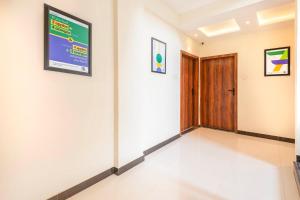 a hallway with a door and a sign on a wall at Treebo Himalayan Homestay in Pune