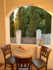 a table with chairs and a bowl of fruit on it at The Barn, at Glenora Avenue in Somerset West +8 photos