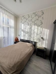 a bedroom with a bed and a wall mural at Центр.Леся Українка in Lutsk
