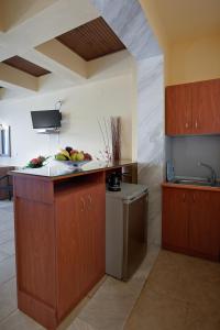 a kitchen with a counter with fruit on it at Seydnaya Apartments & Studios in Neos Marmaras