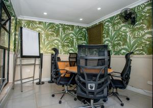 a conference room with a table and chairs in it at Cozy Stead Hotel - Garden House, Gigiri in Nairobi