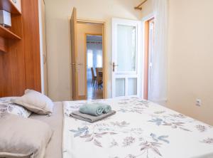 a bedroom with a bed with a towel on it at Apartments Sea Line in Prigradica