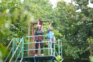 two people on a zip line in the jungle at Nivant Agro Experience in Gorhe +49 photos