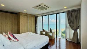 a bedroom with a bed and a large window at Sunrise Gurney Georgetwon in George Town +37 photos