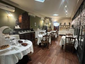 a restaurant with tables and chairs with white table cloth at Liberty Hotel in Turin