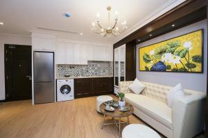 a living room with a couch and a kitchen at Hong Gia Tue Apartment in Hanoi