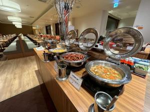 a buffet line with many different types of food at Hotel Kadoman in Aso