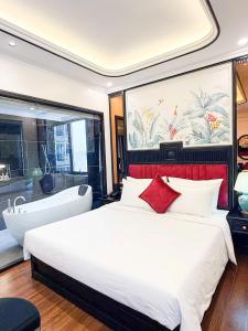 a bedroom with a large bed and a bath tub at Royal Hotel Lâm Hạ in Hanoi +42 photos