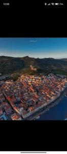 an aerial view of a city with buildings and water at Bomarosa Rooms in Bosa