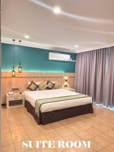 a bedroom with a king sized bed in a room at Heritage Hotel in Tawau