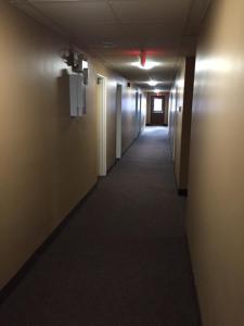 a hallway of an office building with a long corridor at Nights Inn Motel in Thunder Bay