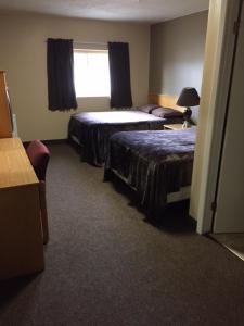 a hotel room with two beds and a window at Nights Inn Motel in Thunder Bay