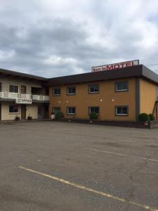 a hotel with a parking lot in front of it at Nights Inn Motel in Thunder Bay
