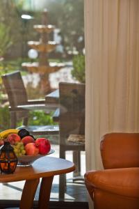 a bowl of fruit on a table in front of a window at Seydnaya Apartments & Studios in Neos Marmaras