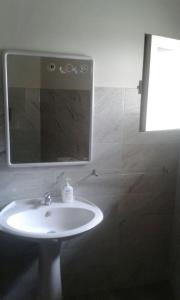 a bathroom with a sink and a mirror at Appartamento le Porte di Ortigia in Siracusa