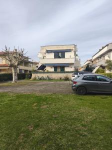 a car parked in a parking lot in front of a building at Il Chicco di Arianna in Torre del Lago Puccini