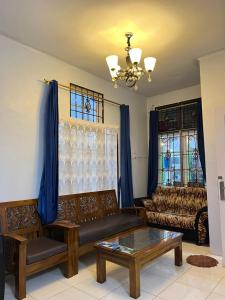 a living room with a couch and a table at Villa Bukit Asri Berastagi in Berastagi
