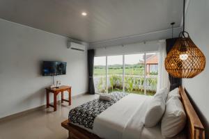 a bedroom with a bed and a large window at Taman Villa Kelating in Krambitan +23 photos