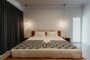 a bedroom with a large bed with two shoes on it at Taman Villa Kelating in Krambitan