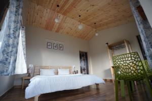 a bedroom with a bed and a wooden ceiling at The Northern Nook in Mukteshwar