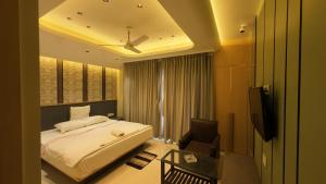 a hotel room with a bed and a television at Hotel Seagull in Digha