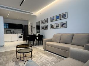 a living room with a couch and a table at SWIFT Suites Limassol in Limassol