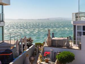 a view of the ocean from the balcony of a building at Calypso Sunset Accommodation in Langebaan