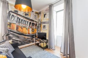 un soggiorno con un dipinto di un treno sul muro di Apartment Yellow Bica a Lisbona