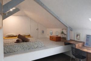 a bedroom with a bed with a teddy bear on it at Chambre de charme dans maison coloniale in Noumea