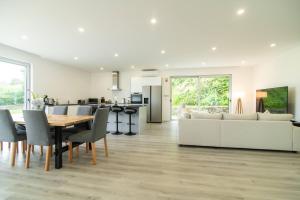 a kitchen and living room with a table and a couch at Seaview Villa with Heated Private Pool in Bretanha