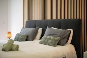 a bedroom with a large bed with pillows and a headboard at Seaview Villa with Heated Private Pool in Bretanha