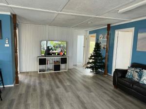 a living room with a christmas tree and a couch at Cervantes Beach Shack in Cervantes +3 photos