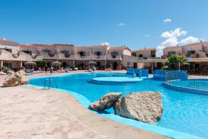 Una gran piscina con rocas en un complejo turístico. en Apartamentos Moon Dreams Los Lentiscos, en Cala en Blanes