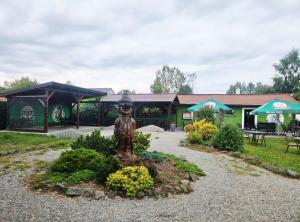 a statue in a garden in front of a building at Penzion u Vodníka in Třeboň