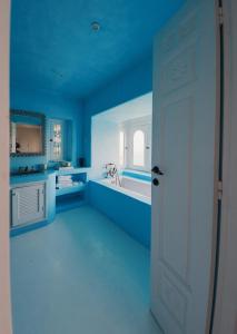 a bathroom with blue walls and a white door at Villa Kahina in Carthage +28 photos