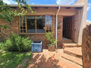 a house with a speaker in the front yard at Spacious & serene townhouse getaway in Bloemfontein