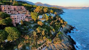 an aerial view of a village on a cliff near the water at Mimosa Seafront Apartment - Free parking Wi-Fi in Varazze