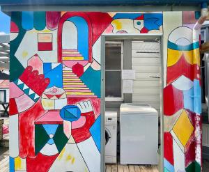 a painting on the side of a refrigerator at Jack's Backpackers in Blenheim