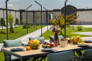 a wooden table with fruit on it with chairs at Homma Aparan with Superpool, 30 min from Yerevan in Aparan