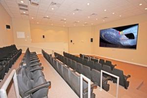 a conference room with black chairs and a screen at Tidewater Beach Resort by Panhandle Getaways in Panama City Beach