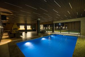 a large blue swimming pool in a building at Homma Aparan with Superpool, 30 min from Yerevan in Aparan +62 photos